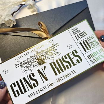 Give a concert surprise with a personalised Guns N' Roses foil ticket. Each ticket is handmade in Ireland and finished with reflective metallic foil. It arrives with a kraft envelope and features a layout inspired by real event tickets.
About This Guns N' Roses Foil Ticket
This keepsake ticket is designed for fans of Guns N' Roses. It works for gift reveals and display keepsakes. The foil gives a mirror shine and the personal message makes the surprise stronger. Ideal for birthdays, anniversaries or concert announcements.