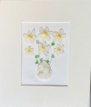 Sea glass daisies in shell vase! Sea glass was hand picked &nbsp;from the beaches and rocks of Sandycove Co Dublin. Each piece is unique and handmade locally. Frames with glass fronts panel are sourced from Wicklow. Free postage in Ireland . Give a sustainable handmade Irish gift!