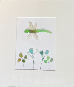 Sea glass dragon fly! Sea glass was hand picked &nbsp;from the beaches and rocks of Sandycove Co Dublin. Each piece is unique and handmade locally. Frames with glass fronts panel are sourced from Wicklow. Free postage in Ireland . Give a sustainable handmade Irish gift!