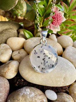 Dendritic Opal is a form of common Opal that has dark dendritic, tubular or orbicular markings within the base Opal, which can be composed of Manganese, the dendrites often appear to be shaped like mosses, ferns or trees