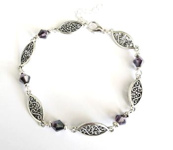 Handmade antique silver filigree bracelet, created with faceted crystal glass beads in a deep purple, silver plated clasp and extension chain. The bracelet is approx.20.32cm/ 8ins in length, plus extension chain approx. 3.8cm/1.5ins. Elevate your style with this beautiful bespoke piece. It arrives in a pretty organza bag, and has free shipping!