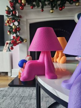 This little guy is the ultimate bedside companion! With its playful "sitting" pose, this lamp doesn't just light up a room&mdash;it adds a burst of personality and charm to any shelf, desk, or nightstand.
​The "Little Helper" Sculptural Night Light
​Meet your new favorite roommate. This quirky, anthropomorphic night light features a unique textured finish and a relaxed posture that brings a sense of fun to modern home decor. Perfect for kids' rooms, creative workspaces, or anyone who loves a bit of "dopamine decor."
​Why You&rsquo;ll Love It

​Playful Design: A unique, humanoid silhouette that looks like it&rsquo;s casually lounging on your furniture. It&rsquo;s a conversation starter even when the light is off!
​USB Powered Convenience: Comes with a high-quality LED USB light included, making it easy to power via your laptop, a power bank, or a standard wall adapter.
​Perfect Lighting, Every Time:

​3 Warmth Settings: Choose between Crisp White (for focus), Neutral (for reading), or Soft Warm (for a cozy nightlight vibe).
​Multiple Intensities: Fully adjustable brightness to help you transition from "productive day" to "sleepy night."


​Tactile Texture: The 3D-sculpted finish gives the lamp a premium, matte feel that diffuses light beautifully across its surface.

​Product Details

​Power: USB-powered (Cable included)
​Lighting: Integrated LED with 3-tone warmth control
​Brightness: Multi-level dimming functionality
​Placement: Designed to "sit" on the edge of tables, shelves
