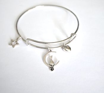 Gorgeous, polished stainless steel bracelet, created with a cute silver tone cat on a moon charm, silver plated cushion heart charm and silver plated open star charm.&nbsp; A lovely lightweight, adjustable bracelet... perfect for cat lovers!&nbsp; It arrives in a pretty organza bag, and has free shipping