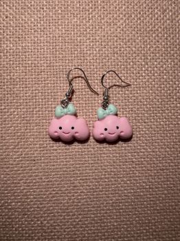 Pink smiling clouds with blue bow