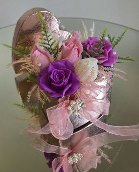 Soap scented roses nicely decorated in a pink heart shape box