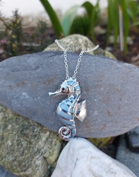 This beautifully crafted pendant is 45mmX22mm in size. The Sterling Silver seahorse is inlayed with blue Mother of Pearl. A chain is sold separately.