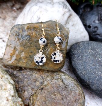 Dalmation Jasper is a naturally occuring stone in beige with black spots. The handmade earrings have an 8mm flat stone set in gold plated Sterling Silver dropping from a 5mm round bead.&nbsp; The earring parts are all made in gold plated Sterling Silver, including the earwires.&nbsp;