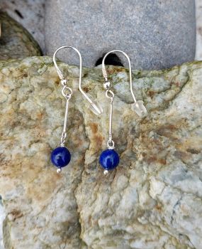 Handmade earrings with a&nbsp; 6mm round grade AAA Lapis Lazuli bead. The Lapis drops from a Sterling Silver bar.&nbsp; &nbsp;