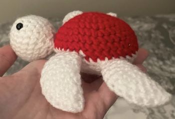 Slow down and meet this adorable little turtle 🐢❤️
This handmade crochet turtle is soft, sweet, and full of cozy charm. Featuring a bright red shell and gentle white body, it&rsquo;s carefully stitched by hand with simple, lovable details that give it a calm, friendly personality. Small enough to fit perfectly in your hand, it&rsquo;s a comforting little companion you&rsquo;ll want to keep close.
Perfect as a gift for turtle lovers, a nursery or shelf decoration, or a cute handmade collectible. Each turtle is made with care, making every one unique