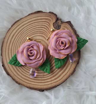 Earrings made with polymer clay, plated gold and dangling tear drop bead.