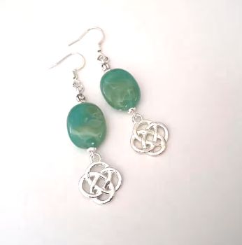 Beautiful celtic knot earrings, handmade in Ireland with quality materials.&nbsp; Created with acrylic marbled beads in a beautiful green, with silver plated celtic love knots.&nbsp; &nbsp; These gorgeous earrings are light and comfortable to wear.&nbsp; &nbsp; &nbsp; &nbsp; Great for lovers of celtic jewellery.&nbsp; &nbsp;Perfect for gifting, or for a personal treat!&nbsp; They arrive in a pretty organza or velvet pouch, and have free shipping!