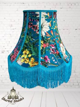 Handmade with care and attention to detail
Bold, colourful floral print on a rich teal base
Decorative braid detailing and flowing fringe trim
Unique scalloped bell silhouette for standout style
Perfect for eclectic, boho, or maximalist interiors
&nbsp;