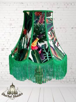 Handmade with care and precision
Eye-catching tropical toucan and botanical print
Luxurious velvet fabric for a rich finish
Decorative green braid and fringe trim
Unique scalloped bell silhouette for a statement look
&nbsp;