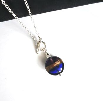 A beautiful glass drop pendant, handmade in Ireland from quality materials.&nbsp; Created with a gorgeous goldsand, handmade lampwork glass bead (2cm) in two tone cobalt blue and deep plum. Lightweight and comfortable to wear... A great pendant for gifting, or for a personal treat!&nbsp;