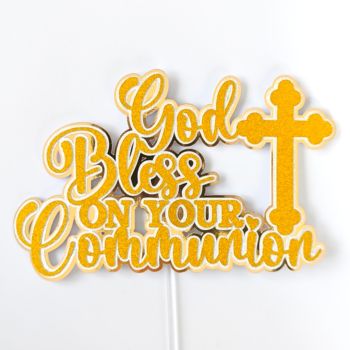 Classic Gold. Timeless Message. Unforgettable Cake.

Some toppers are bold and colourful. This one is something else &mdash; warm, classic, and quietly stunning. The God Bless On Your Communion cake topper is handcrafted from gold glitter cardstock over a gold mirror backing, with a beautifully detailed cross to the right of the flowing script. Rich, warm gold that catches the light with every movement and photographs beautifully against white buttercream, cream fondant, or any classic celebration cake.