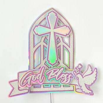 Pink Holographic Church Window with Cross &amp; Dove
The pink version of our most architectural topper &mdash; and it is stunning. Handcrafted from silver-white glitter cardstock with pink glitter outlines over a holographic rainbow backing, it features a precision-cut stained glass church window with a cross at its centre, a dove in flight carrying an olive branch, and flowing God Bless script in a banner at the base.

The holographic backing glows through the intricate cut-out lattice of the church window in shifting pinks, blues, purples, and aqua &mdash; creating a living stained glass effect that is genuinely unlike anything mass-produced. Soft and feminine without being childish, it works beautifully for First Holy Communion, Baptism, Christening, or Confirmation.