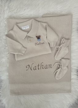 3 piece cosy knit baby set includes&nbsp; collar romper , solid edge blanket , and booties .
Name is embroidered on romper and blanket&nbsp;