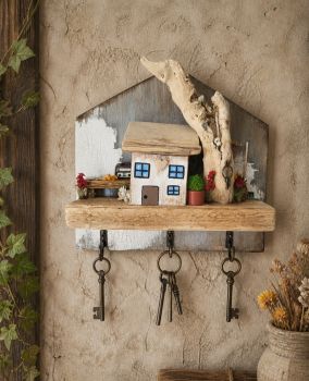 Handcrafted wooden key holder with a beautiful handcrafted tiny house decorated with rustic items!