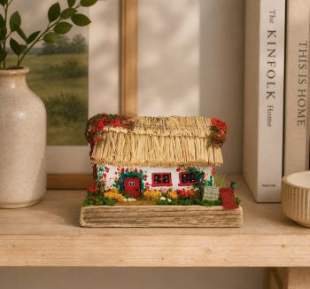 A handcrafted miniature thatched cottage made from reclaimed wood. Features hand-painted red details and a realistic blooming garden!&nbsp; 10/8/7 cm!