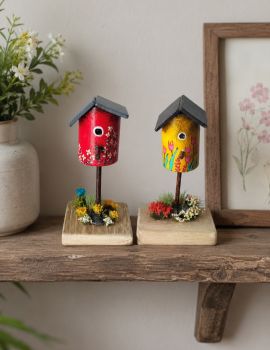 Vibrant hand-painted wooden miniatures featuring realistic floral accents. A perfect, unique gift for nature lovers.