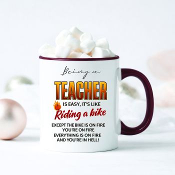 BEING A TEACHER IS EASY&hellip; IT&rsquo;S LIKE RIDING A BIKE
&hellip;except the bike is on fire, you&rsquo;re on fire and everything is on fire. The perfect funny teacher mug for teachers surviving classroom chaos one coffee at a time.
Designed with bold typography and fiery humour, this novelty teacher coffee mug makes a brilliant end of school gift, teacher appreciation present or staffroom conversation starter.
Perfect for primary school teachers, secondary school teachers, SNAs and classroom legends with a sarcastic sense of humour.
Printed on a premium 11oz ceramic mug with vibrant long-lasting print quality. Dishwasher and microwave safe for everyday use.
&nbsp;
A hilarious teacher gift idea from students, parents or coworkers that&rsquo;s guaranteed to get laughs in the staffroom.