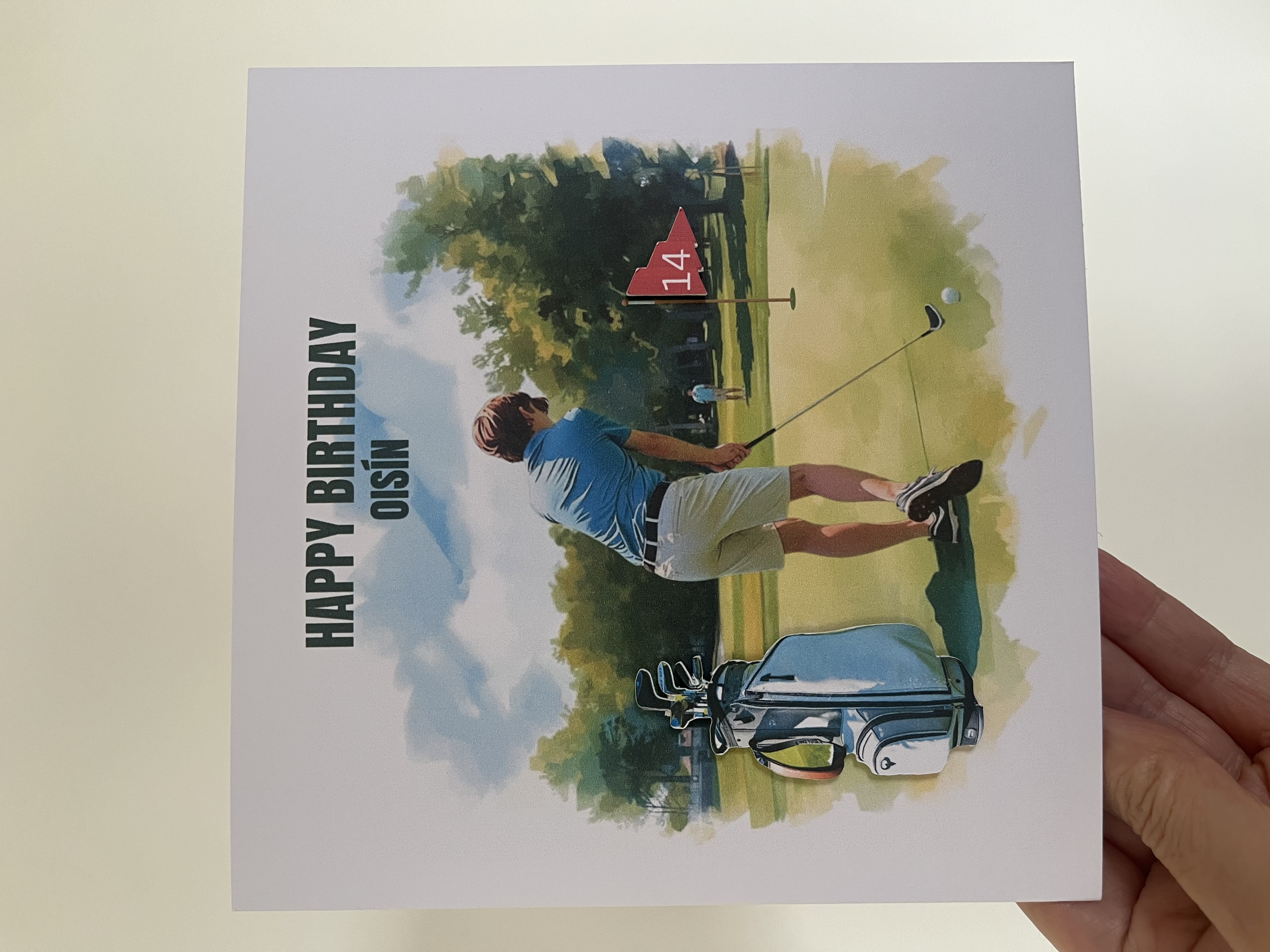 Celebrate their birthday in tee-rific style with a personalised golf-themed birthday card! Featuring a custom golfer with your chosen hair colour, a striking 3D-effect golf bag, and a golf flag displaying their age, this unique card is perfect for any golf lover. A fun and thoughtful keepsake designed to make their special day feel like a hole-in-one.&rdquo; ⛳🎉