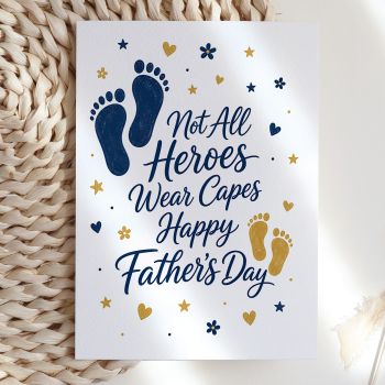 A quietly moving card for the dad who shows up every single day. Elegant flowing script reads "Not All Heroes Wear Capes, Happy Father's Day" in deep navy, surrounded by large and small footprints in navy and gold, with scattered floral details and stars. Simple, sincere, and beautifully composed.