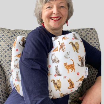 This gift set combines breast cancer surgery recovery pillow and matching chemo port seatbelt pillow are ideal for use directly after surgery, or in the following weeks while healing takes place. This BC support pillow is shaped to fit comfortably under the affected arm, and is filled with high quality polyester filling to a fairly firm finish, perfect to provide adequate support and comfort. This pillow reaches mid chest in width, so it will easily cover the surgery area, and provide support&nbsp; and padding. The chemo port support pillow gives support when used in a car while treatment is ongoing and afterwards.
The BC pillow measures 43cm wide X 37cm long and 10 cm in depth. The chemo port support pillow measures 18cm wide X 8cm long and 4cm in depth. This lots of different cats print is soft and breathable. All pillows come with a handmade with love by Rodgerson Handcraft label and are reversible.
