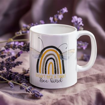 Bring humor and positivity to every coffee break with this adorable and cheeky &ldquo;Don&rsquo;t Bee A Twat, Bee Kind&rdquo; 11oz ceramic mug. Featuring a stylish bee-inspired rainbow design with delicate wings and modern typography, this mug combines cute aesthetics with sarcastic humor for the perfect everyday coffee cup.