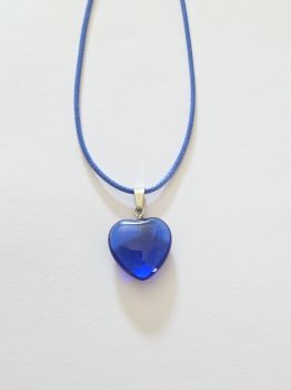 A small crystal heart on a leather rope necklace. The leather is coloured blue to match the gem.