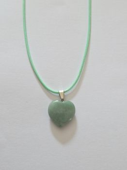 A small crystal heart on a leather rope necklace. The leather is coloured green to match the gem.&nbsp;