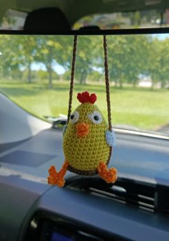 Add a charming touch to your car with our adorable Chicken on a Swing mirror decoration! Crafted with attention to detail, this playful ornament brings personality and fun to your vehicle. Easy to attach and lightweight, it&rsquo;s the perfect way to brighten your drive.&nbsp;The Chicken height is approx. 7 cm.The length of the swing is approx. 15 cm.&nbsp;If you want to use a different color or another swing length please contact me via message and we'll make it without any additional chargeTh Chicken is fully handmade, so there can be some variation from piece to piece. These make them unique!