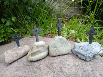 Hand-Forged Iron Cross on Local Kerry Beach Stone
​Bring a piece of the Wild Atlantic Way into your home with this unique, handcrafted sculpture.
​Each cross is individually hand-forged using traditional blacksmith techniques in my workshop near Caragh Lake, County Kerry. The ironwork is securely mounted into a unique beach stone hand-selected from the shores of Cromane and Rossbeigh.
​Because every stone is shaped by the Atlantic ocean and every cross is hammered by hand, no two pieces are ever identical. A deeply meaningful gift for a new home, a wedding, or for loved ones abroad looking for a genuine, tangible connection to Ireland.
​100% Irish Craftsmanship: Made in Killorglin, Co. Kerry.
​Materials: Hand-forged iron &amp; authentic local beach stone.
​Size: [Approx.15-20cm]
​Note: Natural variations in the stone make every single piece a true one-of-a-kind.