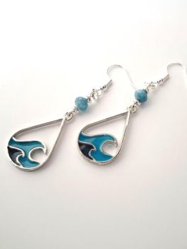 Gorgeous 'wave' earrings, handmade in Ireland, beautifully enamelled in shades of blue. enhanced with natural jade stones also in blue (dyed).&nbsp; &nbsp;Light and easy to wear. Perfect for summer... great for gifting, or a personal treat!