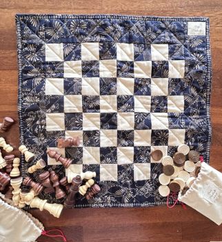 Each quilted Chess/Checkers/Tic Tac Toe board is handmade and designed as a reversible board, allowing one side to be used for chess/checkers(draughts) and the other for games like Tic Tac Toe (X&rsquo;s and O&rsquo;s).&nbsp;
It is suitable for indoor and outdoor play at the beach, camping trips or picnics in the park.
Compact, light and portable ... take it with you and play anywhere. A perfect gift for anyone who loves classic games.... it is sure to become a family heirloom!&nbsp;
If you're buying this as a gift just write your message in the "Gift Message" box, let us know the shipping address and we will post it to the lucky recipient!
Standard Delivery on this item includes tracked postage.