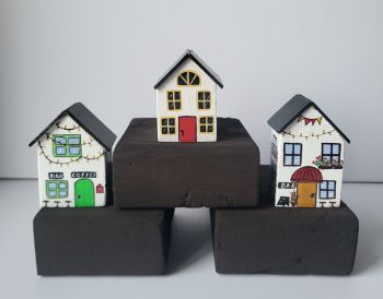 Add a touch of whimsical architectural art to your living space. This set of 3 houses are individually hand-painted to each side and varnish, approx. 4/3/7 cm!