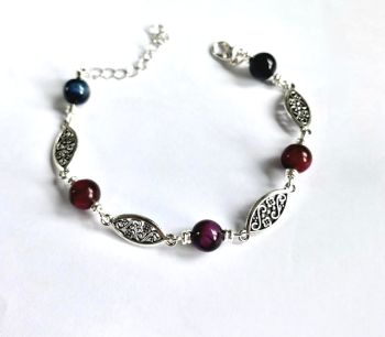 Bring a bold and unique look to your wrist with this striking bracelet!&nbsp; It pairs detailed silver tone filigree links with smooth polished tigers eye beads.&nbsp; Layer this beautiful bracelet, or wear it on it's own as a statement piece!