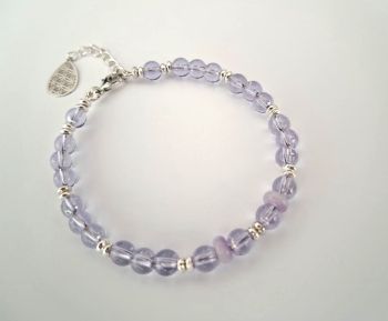 Add a subtle pop of colour to your wrist with this beautiful bracelet, created with gorgeous light lavender glass beads and silver tone accents, perfect for every day wear!