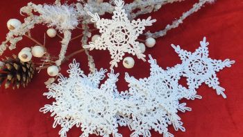 Shop this beautiful set of 12 hand-crocheted 11.5cm white lace snowflakes by BusyCraftyMum. Festive cotton tree ornaments proudly handmade in Dublin, Ireland.