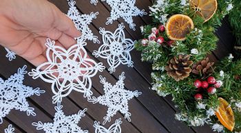 Shop beautiful handmade crochet snowflake Christmas ornaments (set of 12) crafted in Ireland. Perfect 4.5" white cotton lace stars for tree decor &amp; gifts!