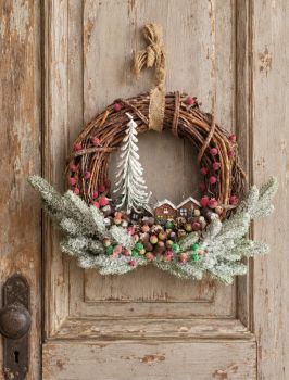 Beautiful winter wreath with natural branches, wooden houses and a lot of realistic greenery. Perfect for a wall or door, or as a cute gift for a new house. 28/28 cm.