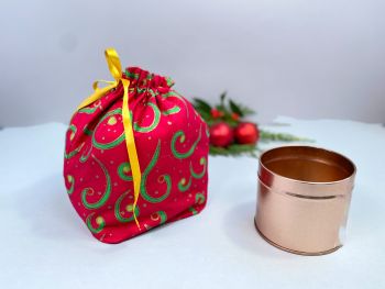 This gift bag is made using green and gold swirls on red fabric. This gift bag is finished to a high standard, and is drawstring tied with coordinating gold ribbon. It is reusable gift wrapping and will make a great tradition for wrapping Christmas presents.&nbsp;