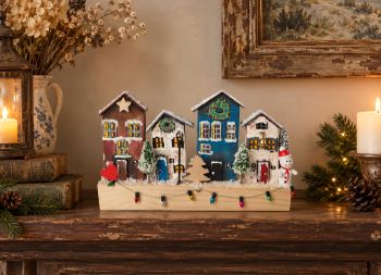 This unique 20 cm handcrafted wooden winter village, hand-painted with acrylic and beautifully decorated, is perfect for any interior or as a cute gift.