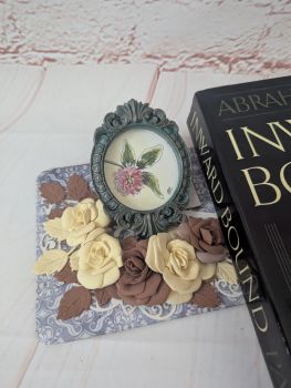 A hand-painted watercolour miniature featuring clover, set in a handmade frame.