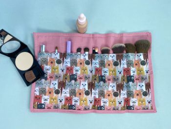 This cosmetic holder and make up brushes in smiling cats print. This medium sized cosmetic bag is ideal for your teenage girl, or the cat dog lover in your life. It is fully lined with matching cotton fabric. It has a zipper to close.&nbsp;
This bag will fit standard cosmetics, period pads or tampons packets. The bag measures 24cm long X 18cm wide with a handmade tag added. The make up brushes will hold 10 brushes, slim cosmetics, if needed or can&nbsp; be used for everyday uses.&nbsp;&nbsp;