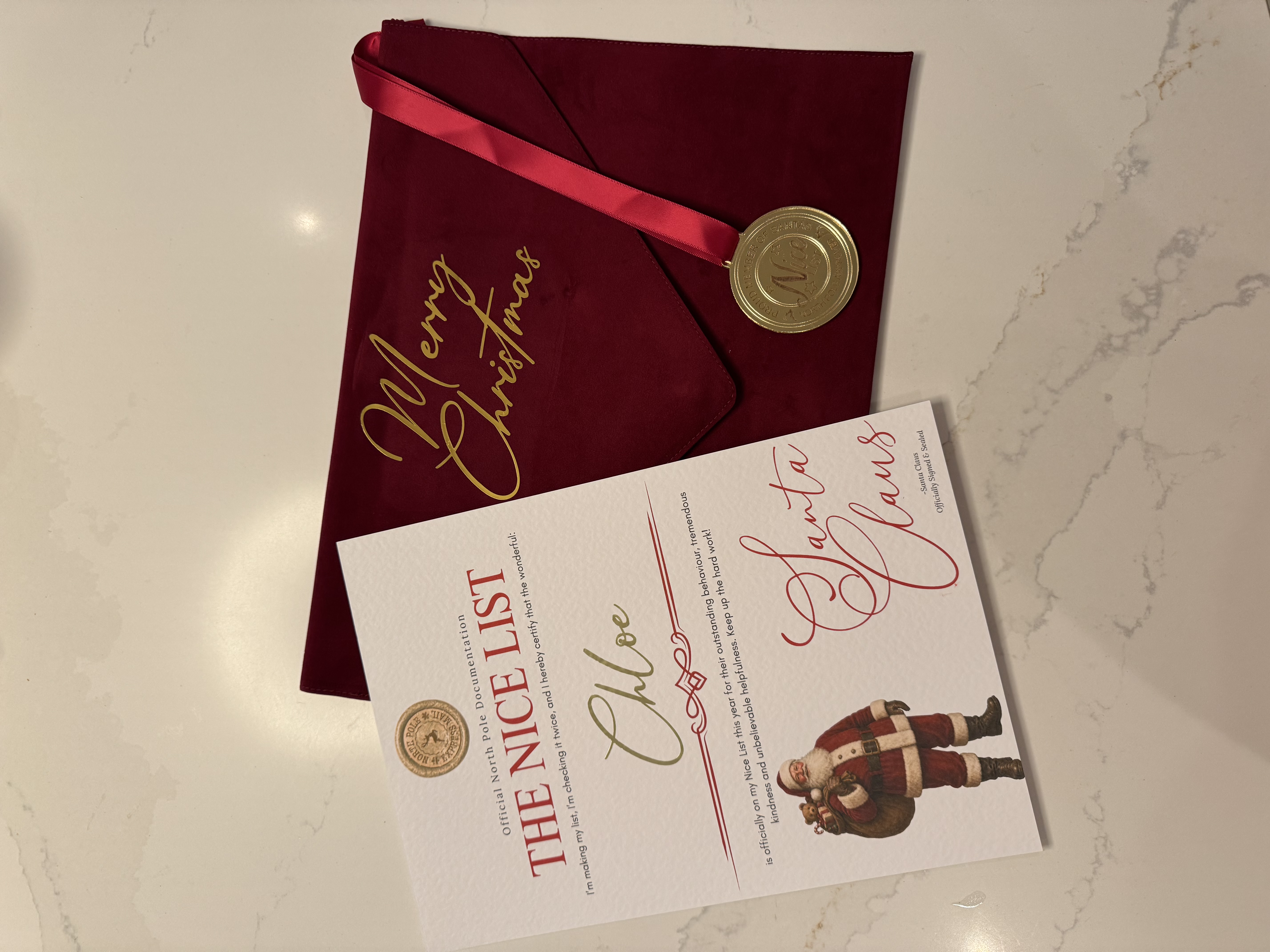 Luxury Red Velvet Envelope Folder with Nice List Cert &amp; Medal
Brushed&nbsp;velvet envelope folder personalised with a name on the front and Merry Christmas on the top in metallic vinyl with a personalised nice list certificate and nice list medal.