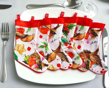 Decorate your Christmas table with my individual, fun Christmas mini stockings cutlery holder set. Make them a Christmas tradition for years to come. Each of the set of 4, 6, 8, 10 and 12 stockings sets are made cute robins 100% Christmas cotton fabric, topped with red Christmas ribbon, backed with festive red felt.