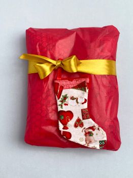 Decorate your Christmas gifts/presents with these cute, individual miniature Christmas stockings for that finishing touch. They are filled with polyester toy filler and Christmasy spices like cloves, Star Anais, cardamom for a great festive smell. They are sold in sets of 6, with multiples sets available at checkout. Each stocking measures 10cm in length X 5cm wide.They are made from a variety of Christmas fabrics, topped with festive red ribbon and an additional ribbon to allow for hanging.&nbsp;&nbsp;