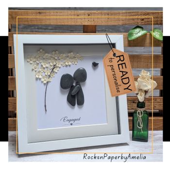 A lovely gift to congratulate them on their engagement, and a lovely memento to remind them of the happy day when they committed to each other. This piece features a couple embracing under a blooming tree. Underneath it reads &ldquo;Engaged&rdquo;, their names and date of engagement.