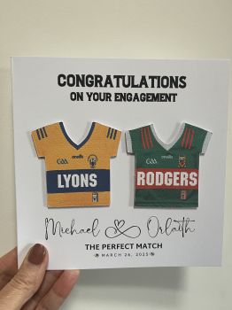 A beautiful handmade card featuring the couple's names and engagement or wedding date. Personalised with county or club jerseys, each adorned with the couple's surnames, making this a truly unique and meaningful keepsake.